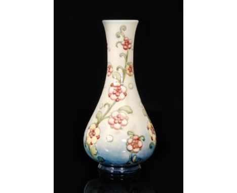 A Moorcroft vase of globe and shaft form decorated with pink and yellow flowers against a pale green wash ground, impressed s