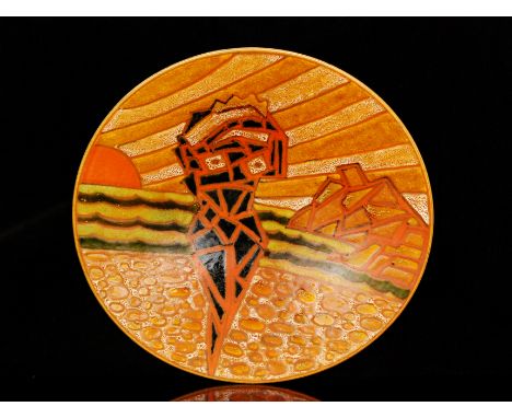 A large Poole Pottery Studio charger decorated with an abstracted female figure on the beach with a sunset and mountains in t