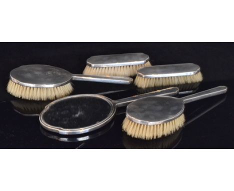 A George VI hallmarked silver mounted part dressing table set, with shaped edge and part engine turned decoration, each with 