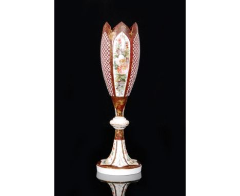 A large 19th Century Bohemian tulip vase in the manner of Moser with spread foot, knopped stem and tall body cased in opal ov