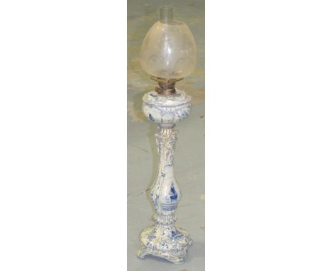 An early 20th Century Royal Bonn Delft oil lamp with etched glass shade.