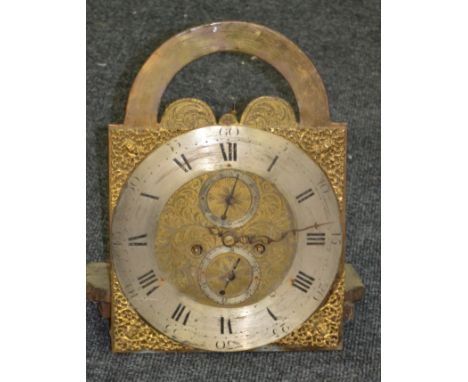 An 18th Century brass eight day longcase clock movement, open arch dial and silvered chapter ring with pierced corner spandre