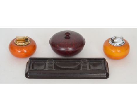 A 1930s Bakelite rectangular pen tray together with two Callibri cushion shaped table lighters and a trinket jar and cover (4