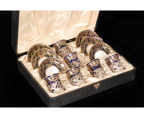 An early 20th Century George Jones Crescent China cased set of six coffee cans and saucers each decorated with gilt swags and