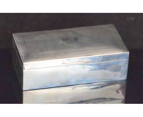A hallmarked silver rectangular cigarette box with engine turned decoration to hinged cover, length 17cm, Birmingham 1939.