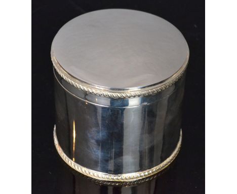 A modern hallmarked silver circular tea caddy of plain form with gadroon borders to base and hinged cover, height 9.5cm, Birm
