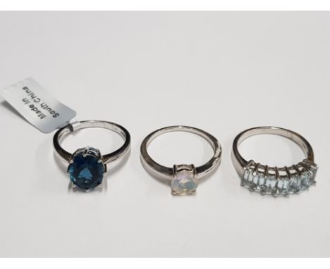 THREE SILVER BLUE AND OPAL STYLE RINGS STAMPED ONE WITH SHOP TAG SIZES R 1/2 T 1/2 AND U 9.4G GROSS