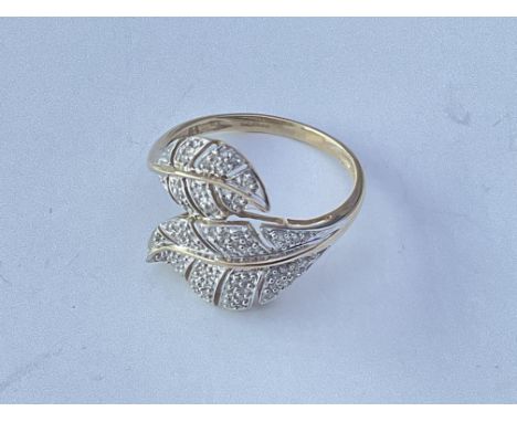 A 9ct gold ring in the form of open leaves set with a chip stones. Approx 3g. Ring size approx U.