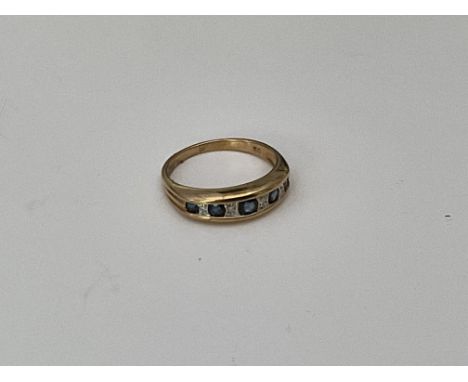 A gold band set with sapphires and diamonds. K.