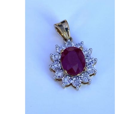A 9ct yellow gold oval ruby and diamond pendant (ruby approximately 1.80ct).