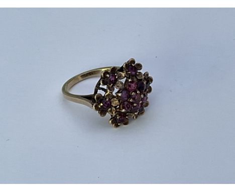 A 9ct gold and ruby floral design ring, O.