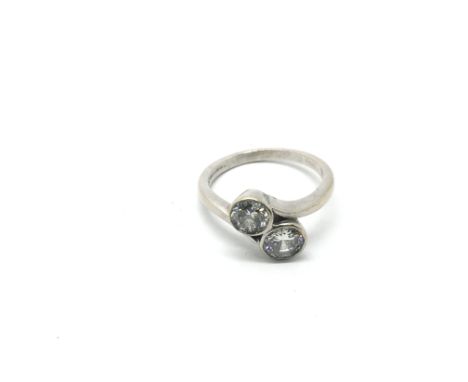 An 18ct white gold two stone diamond crossover ring, larger stone approx 1.25ct, smaller stone approx 1ct, approx size Q-R an