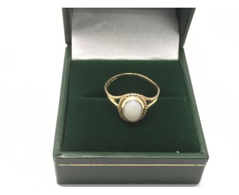 A 9ct gold ring set with an opal, approx size K-L.