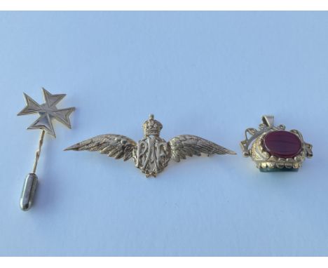 A RAF 9ct gold brooch, a 9ct gold Maltese cross stick pin and a 9ct gold hard stone set spinning fob. Approx 6g.