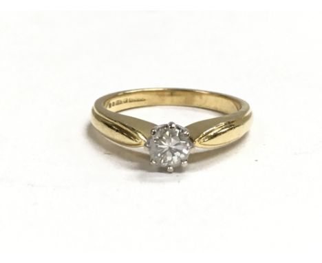 An 18ct gold ring set with a single diamond. The approximate ring size is k.