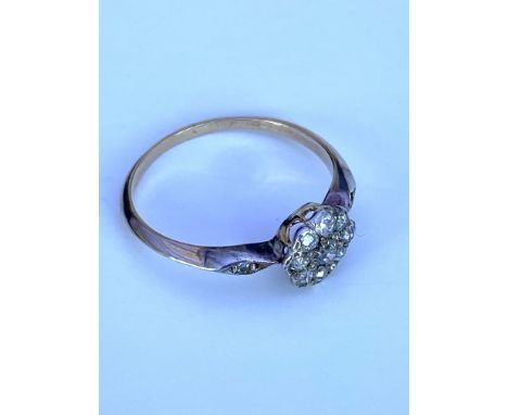 An unmarked old cut diamond daisy cluster ring. (O).