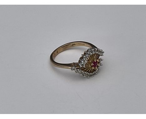 An unusual 9ct gold ruby and diamond cluster ring.