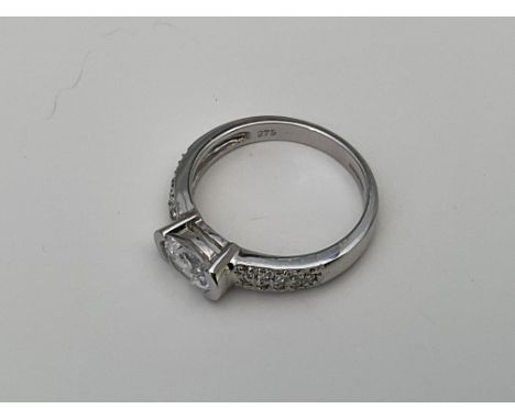 A 9ct white gold ring set with a central oval cut CZ.Approx 2.8g, M.