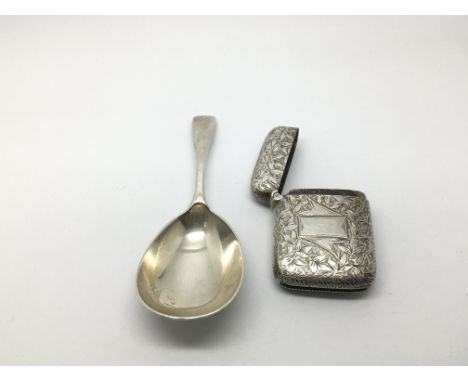 A silver caddy spoon and a silver vesta case (2).