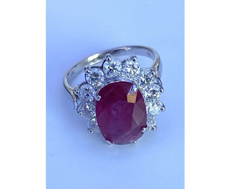 An 18ct gold large oval ruby and RBC diamond cluster ring, Ruby 3.71ct, Diamonds 1.65ct. (O).