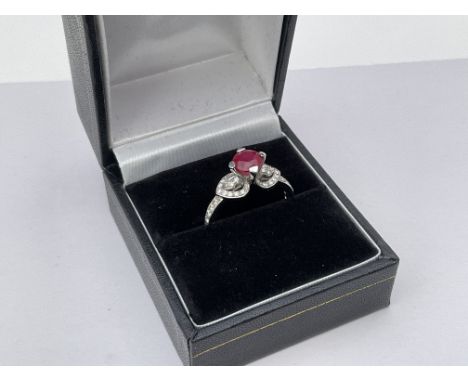 An 18ct Ruby solitaire surmounted by diamond set shoulders. M.
