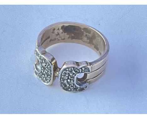 A 9ct gold buckle ring set with chip, stone diamonds. Approx 6g. Ring size approx P.