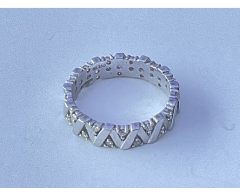 An 18ct white eternity white gold ring set with a geometric pattern of small stone diamonds. Approx 5g. Ring size approx P.