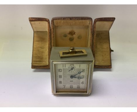 A small 1920s JAZ cased travelling alarm clock (not in working order).