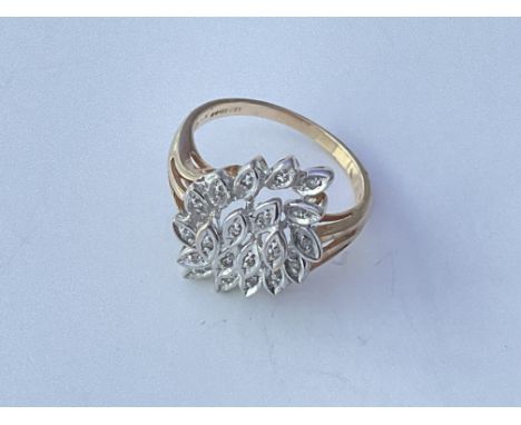 A 9ct gold ring set with small diamonds in asymmetrical pattern. Approx 3g. Ring size P.