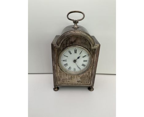 A hallmarked silver carriage clock with marks for William Comyns, London 1909. Height. 15cm not inc handle.