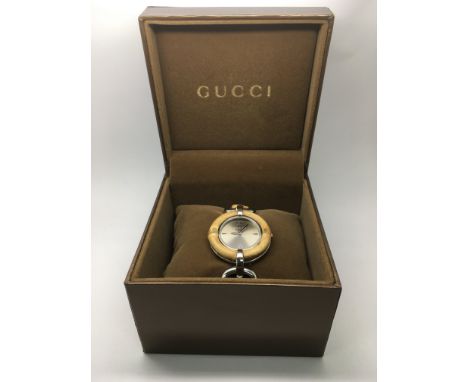 A boxed Gucci ladies bamboo watch with manual.