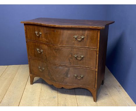Regency gentleman's large figured mahogany serpentine front commode of 3 long graduated drawers with brass drop handles benea