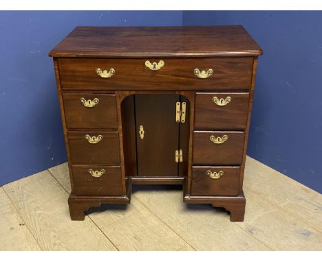 A very good George III, Cuban mahogany kneehole writing desk of 7 drawers, flanking a kneehole cupboard with original brass h