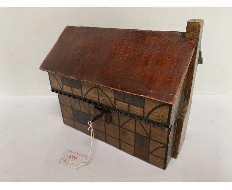 Wooden tea caddy in the form of an Elizabethan cottage. 21cm L x 19cm H. Condition: generally good, minor wear with key 