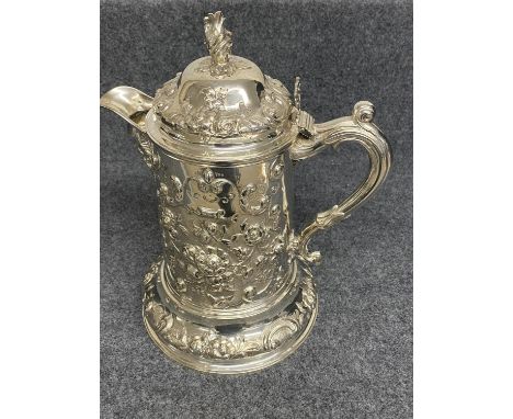 Victorian silver flagon profusely chased with repoussé foliage &amp; scrolls, a crest to the cartouche, a mask spout, the hin