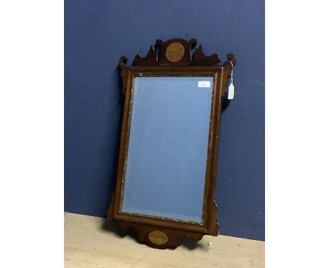 Small early C18th fret cut mahogany bevelled wall mirror with gilded inset frame below a shell inlaid finial, the bevelled ob
