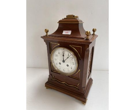 AN English C19th Mahogany bracket clock, with brass dial, black painted numerals and twin winding holes 