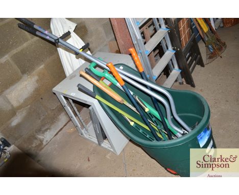 A plastic wheeled garden caddy and a quantity of tools