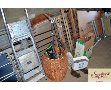A wicker basket and contents of garden tools