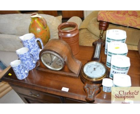 A graduated set of storage jars; a small banjo thermometer barometer; a 1930's mantle clock; a quantity of blue and white jug
