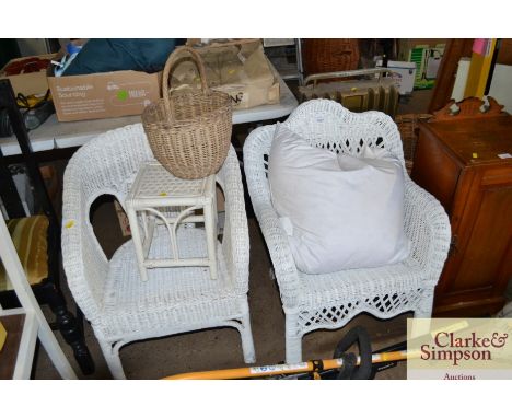 Two white painted wicker garden chairs, small stool and a wicker basket