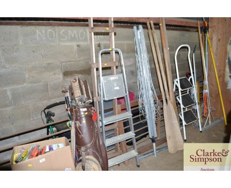 A small wooden ladder; a wooden A frame and a set of aluminium steps