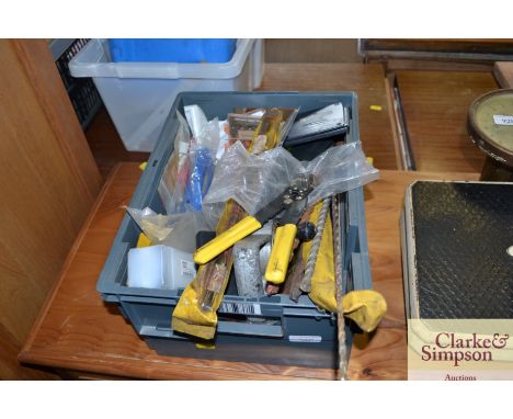 A plastic tray containing drill bits; wire cutters and other tools