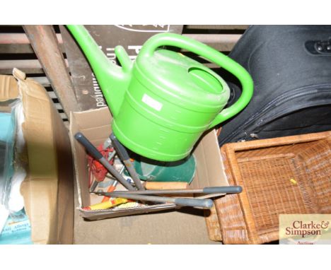 Two watering cans and a box of various garden tools
