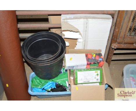 A plastic crate containing garden edging tools etc.