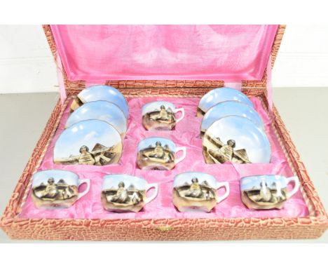 CASED PORCELAIN SET OF COFFEE CUPS AND SAUCERS DECORATED WITH EGYPTIAN PYRAMID SCENES