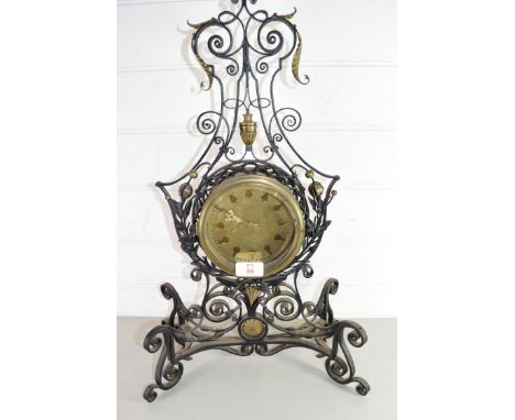 20TH CENTURY MANTEL CLOCK IN ELABORATE IRON FRAMED SURROUND