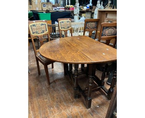 20th century oak dropleaf table with four chairs,in tapestry style fabric table is in good condition.&nbsp; Chairs are good b