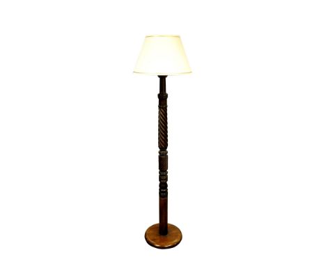 A Victorian carved mahogany standard lamp, the column carved with wrythen fluted and stylised acanthus decoration, on a circu