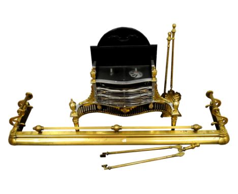A large Victorian brass fireside fender, 144cm wide with scrolling sides and central squared rail together with associated br
